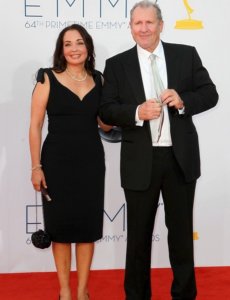 Ed O’Neill and his wife in a black suit at an Emmy award ceremony