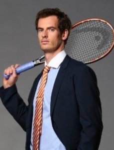 Andy Murray with a black suit, red stripped tie and a tennis racket