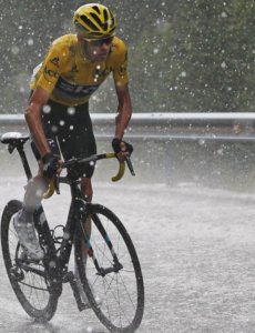 Chris Froome cycling during a snowing period