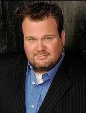 Eric Stonestreet with a beard posing for a photo