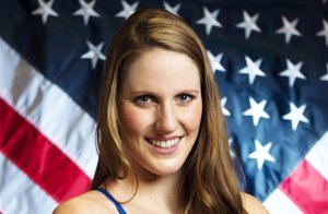 Missy Franklin smiling with the american flag behind