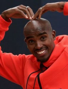 Mo Farah doing the mobot in a casual outfit