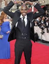 Mo Farah doing the mobot in a suit
