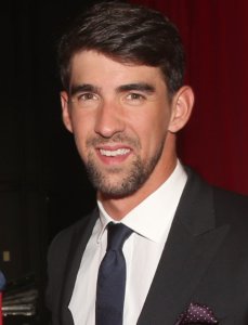 Michael Phelps smiling in a suit
