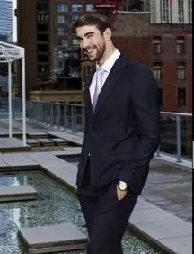 Michael Phelps full body image in a suit, smiling