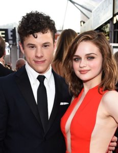 Nolan Gould in a smoking with Joey King wearing a red dress