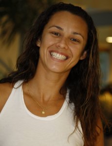 Talita Antunes smiling in a white shirt